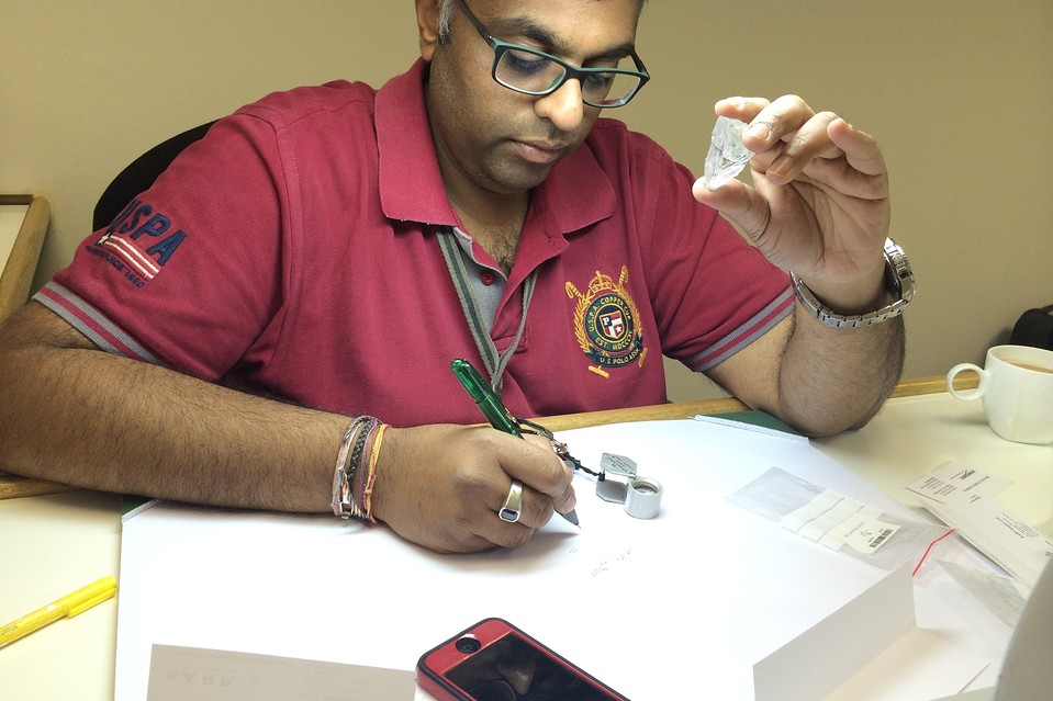 Karp Group's N.B. Parag evaluates a rough diamond of more than 100 carats on Oct. 7 at the offices of Lucara Diamond Corp. in Gaborone, Botswana.