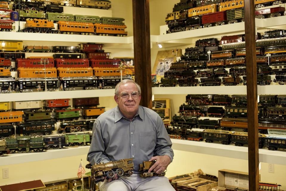 Ed Prendeville,an early small investor in Berkshire Hathaway, holds a 1929 Ives Prosperity Special, inside the toy-train room at his home.